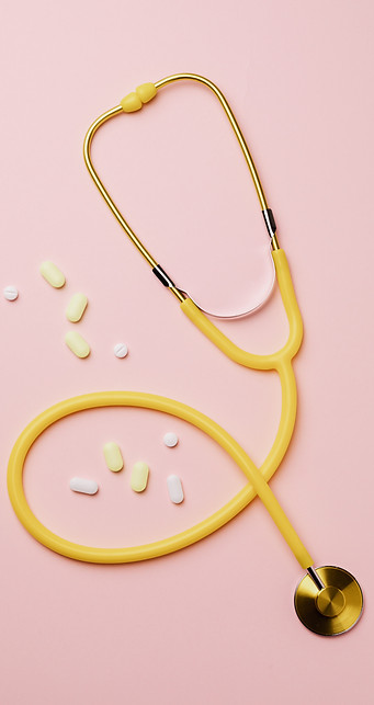 yellow-stethoscope-and-medicines-on-pink-background-4047077.jpg